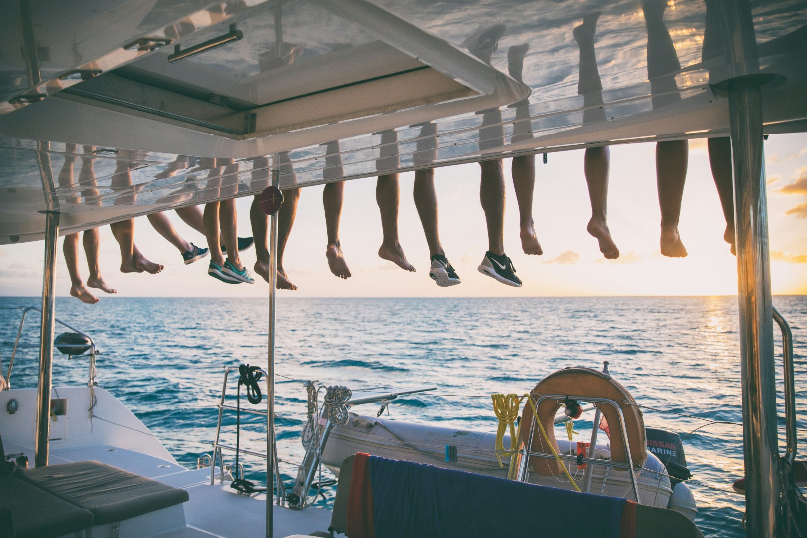 Family enjoying a catamaran vacation with Greek islands in the background